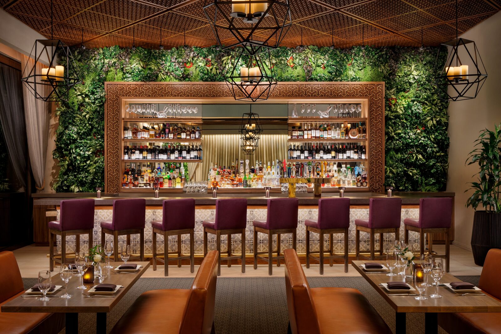 The Lounge & Terrace at golden hour with velvet stools and candlelight