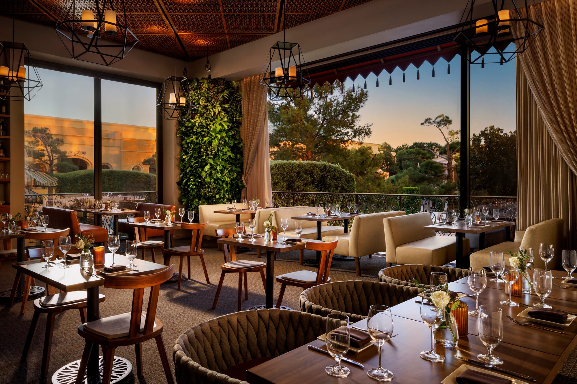 The Garden Lounge with woven banquettes and floor-to-ceiling windows